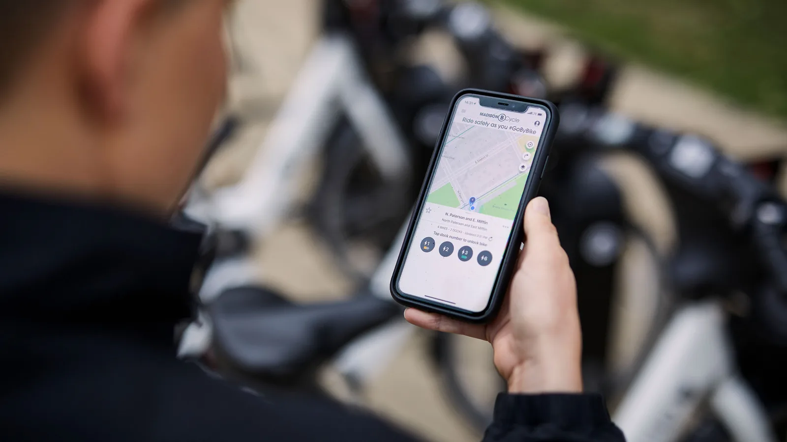 woman looking at the BCycle app on her smart phone