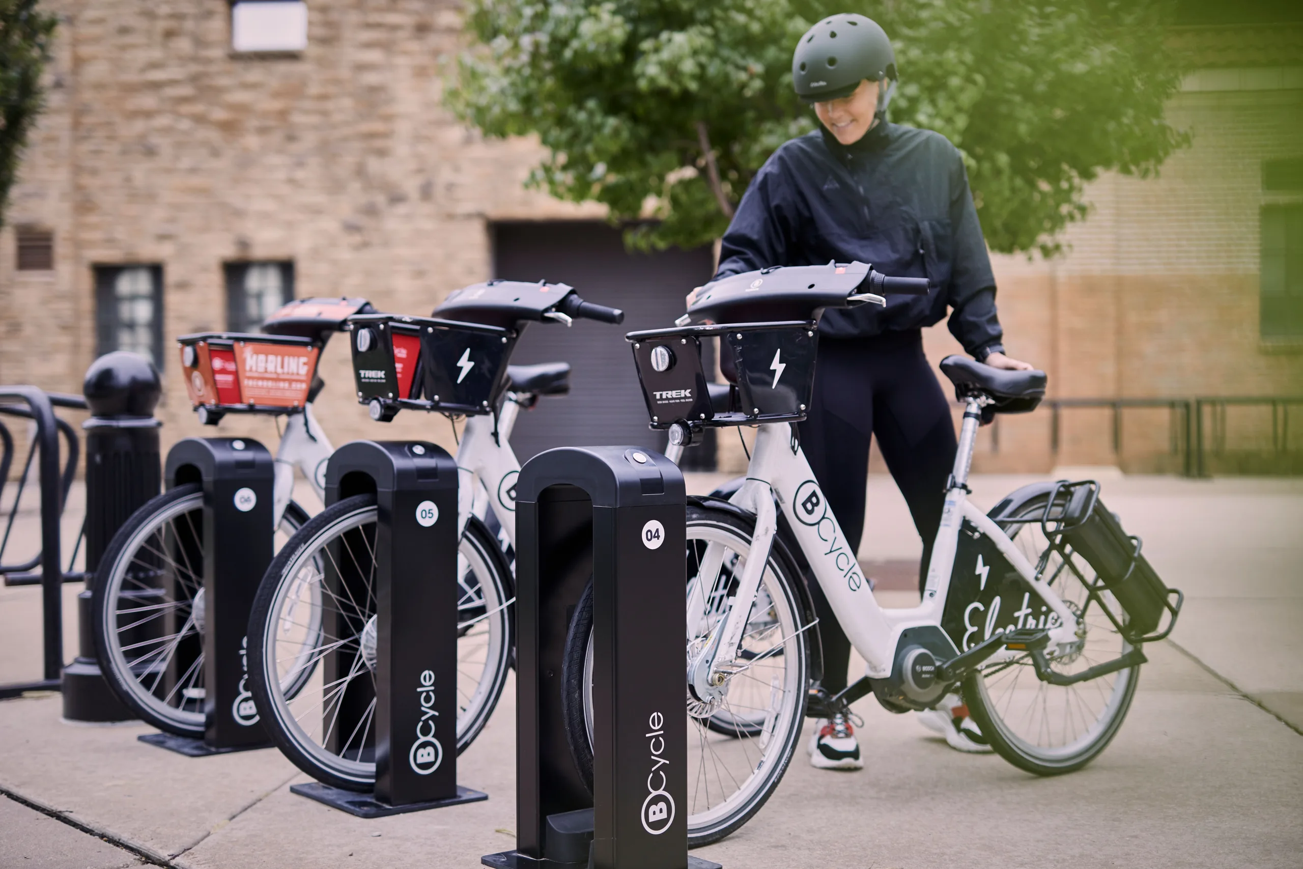 Woman removing BCycle bike share bicycle out of the dock